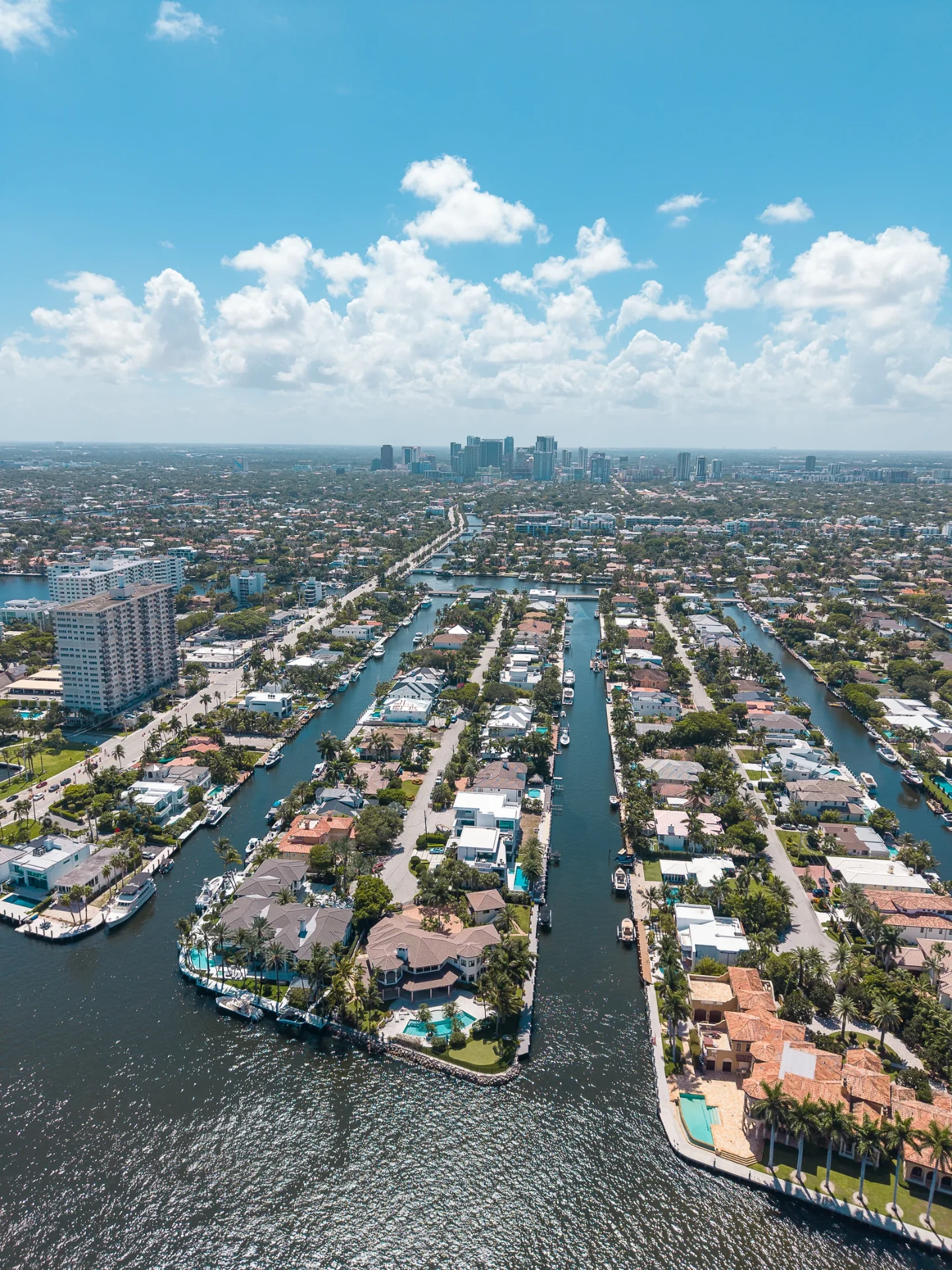 Aerial drone photo of the Las Olas Isles waterfront homes and canals in Fort Lauderdale with the city skyline beyond